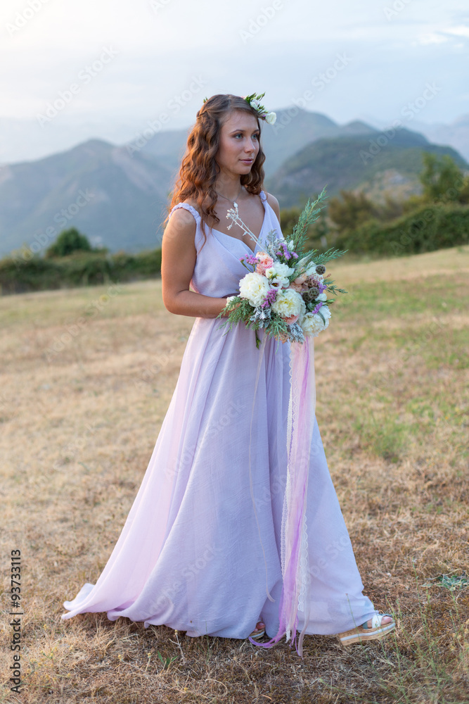 Attractive bride is holding a wedding bouquet