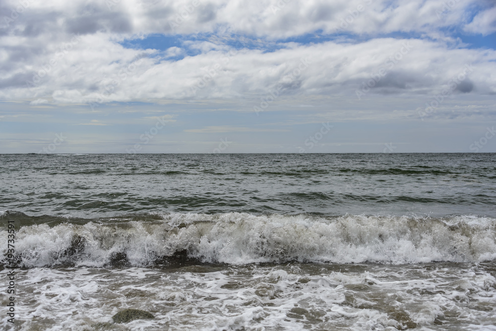 Waves after a storm.
The waves rolled ashore and breaking on the rocks .