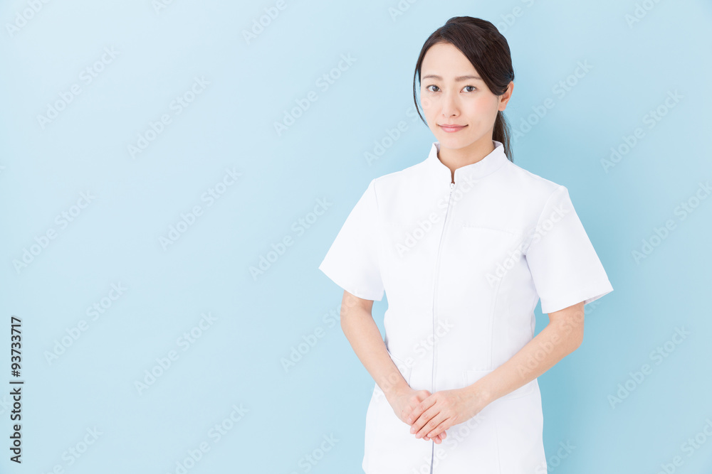 portrait of asian nurse on blue background