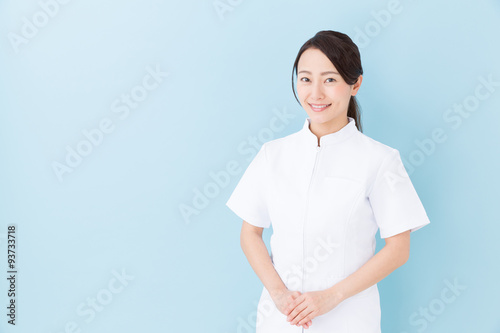 portrait of asian nurse on blue background