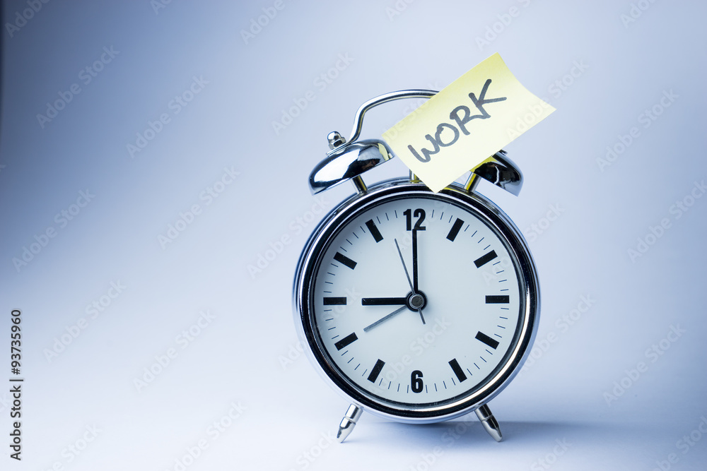 Alarm clock with sticky paper note on white background.. Alarm clock with sticky paper note on white background..