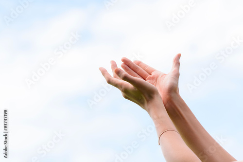 Young woman hand on sky