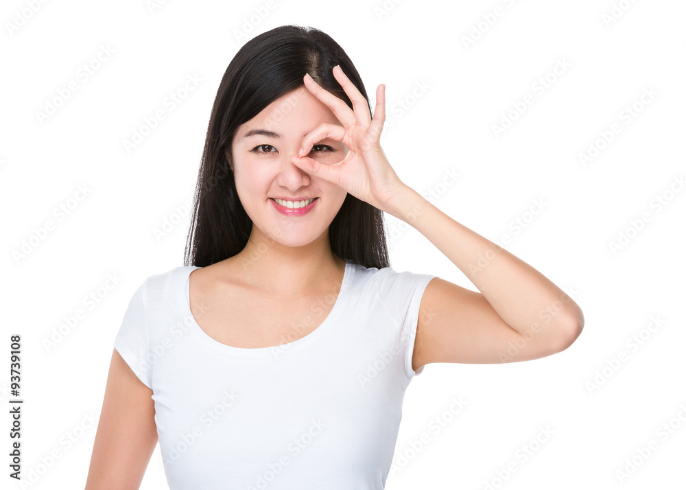Asian Young woman with ok sign on her eye Asian Young woman with ok sign on her eye