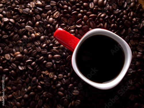 Coffee beans and a red coffee mug