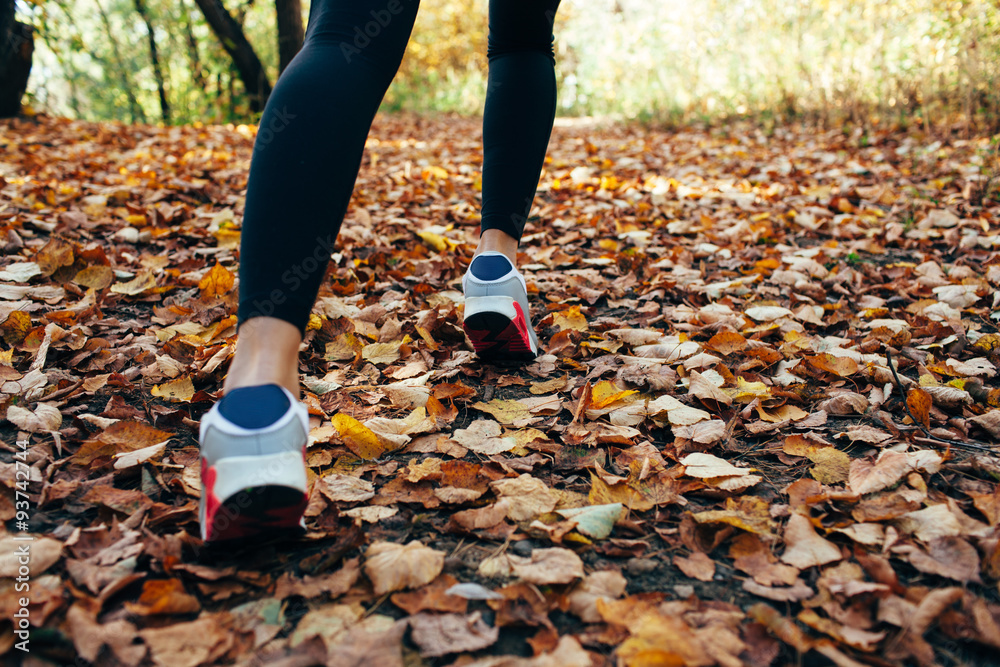 woman runs for fall foliage, shoes closeup