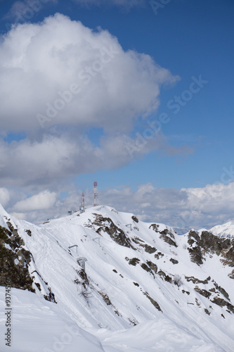 telecommunications tower with cloudy sky in the mountains 