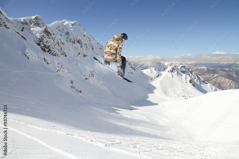 Flying snowboarder on mountains Flying snowboarder on mountains