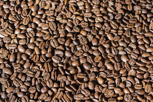 Background of roasted coffee beans lit by the sun