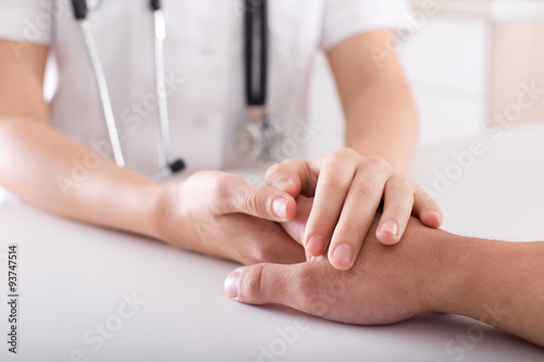 Doctor's and patient's hand photo