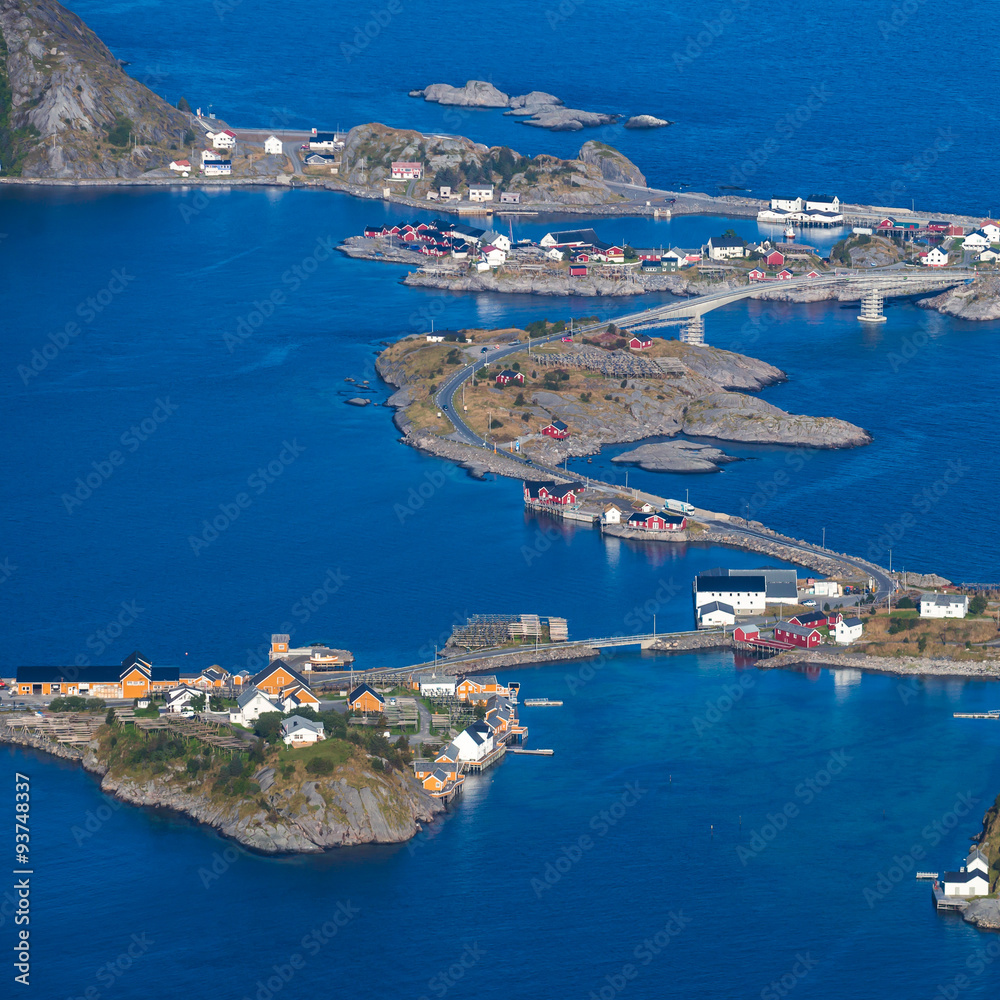 Beautiful aerial summer colorful view of scandinavian city, Reine, on different islands with red houses, ships and boats connected with bridges, in ocean, Norway, Lofoten Islands
