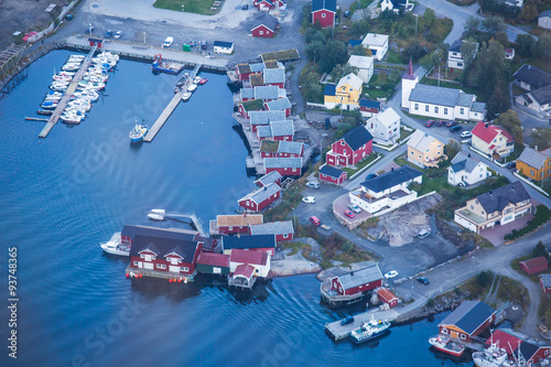 Beautiful aerial summer colorful view of scandinavian city, Reine, on different islands with red houses, ships and boats connected with bridges, in ocean, Norway, Lofoten Islands 