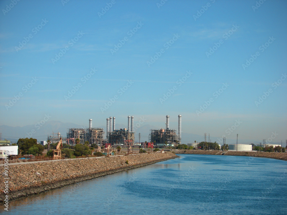 industrial factory in the distance along peaceful river