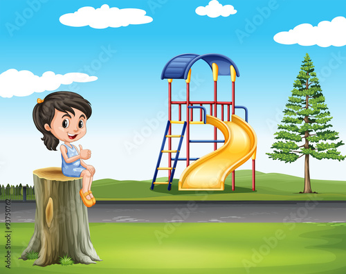 Girl sitting on log at the park