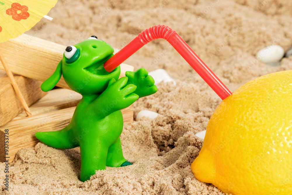 Green clay monster drinking lemon juice closeup Green clay monster drinking lemon juice closeup