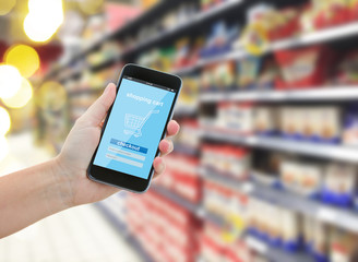 hand holding a modern smartphone in supermarket