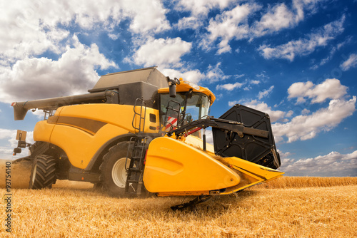 close view of modern combine harvester in action.