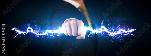 Business man holding electricity light bolt in his hands