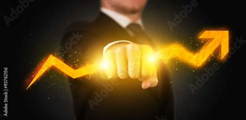 Business person holding a hot glowing upright arrow