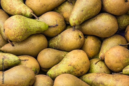 a group of green pears in a market  