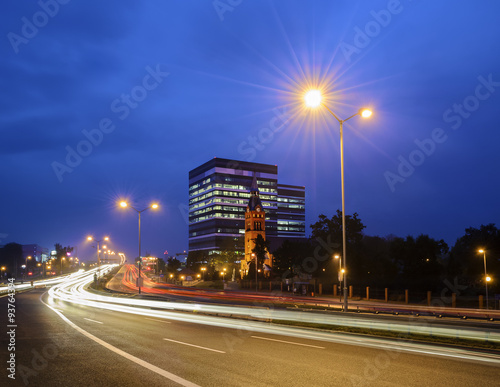 The church, on the background of office building, the highway i