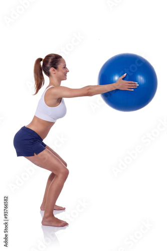 young woman exercising with fitness ball