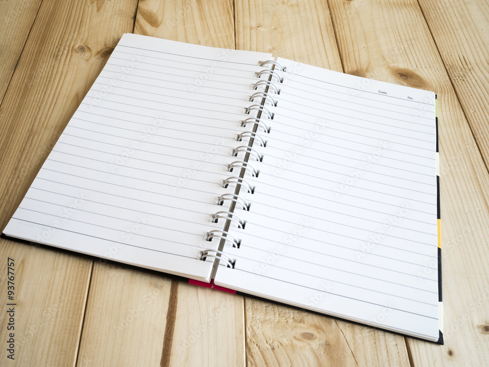 Notebook page 1 - One blank notebook page on wood table, business concept Notebook page 1 - One blank notebook page on wood table, business concept