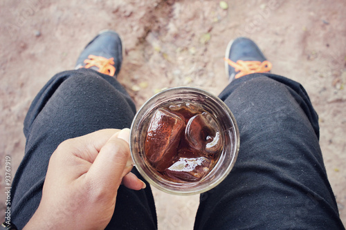 Selfie of hand with cola drink