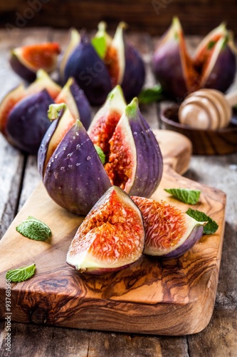 Fresh ripe figs with honey and mint leaves