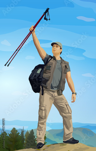 Man tourist with hiking poles in hand standing on mountain top