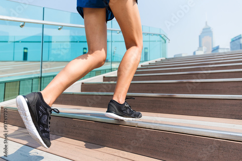 Sporty girl stepping on the staircase