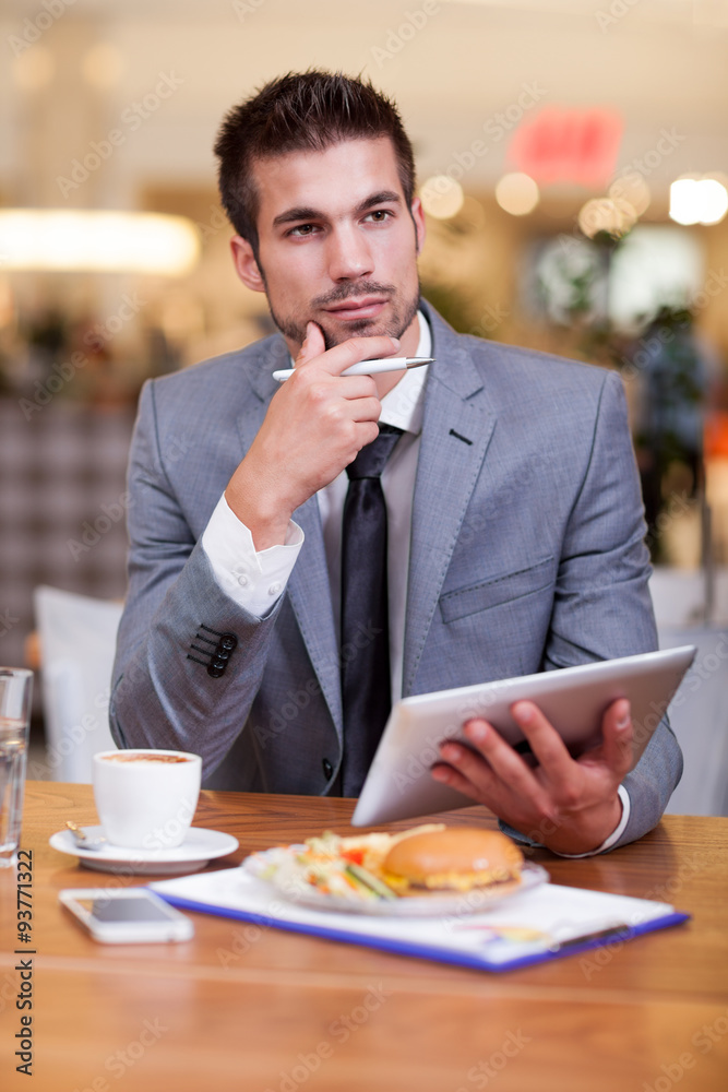 young businessman in the coffee break working on his laptop young businessman in the coffee break working on his laptop