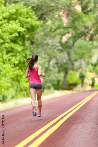 Running woman - female runner training on road