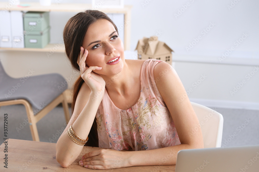 Attractive businesswoman sitting on desk in the office Attractive businesswoman sitting on desk in the office