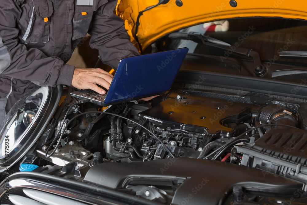 Car mechanic with a tablet