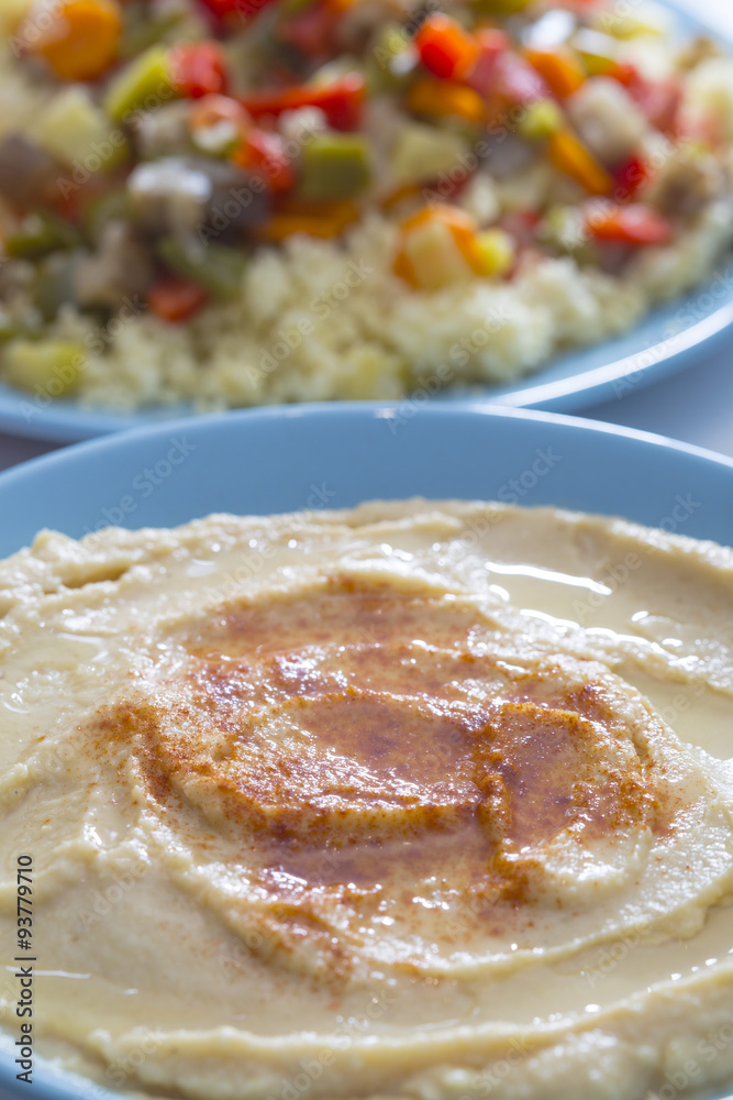 Tasty arabic hummus food served on a blue bowl with rice and spices