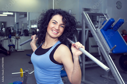 young girl engaged in bodybuilding in the gym