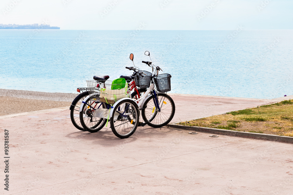 Two attached bicycles on the coast