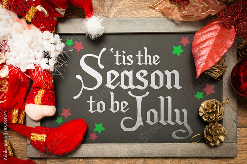 Blackboard with the text: Tis The Season to be Jolly in a christmas conceptual image photo