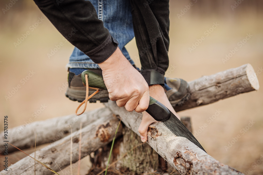 yang Man cutting a wood with a hand saw yang Man cutting a wood with a hand saw
