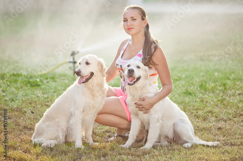 Beautiful woman with two labradors in a forets