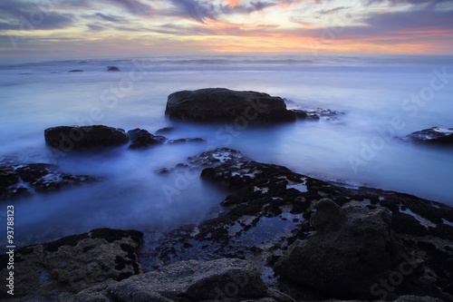Twilight / A seascape at twilight, rocks washed by the sea under a sunset afterglow © giampierotorello