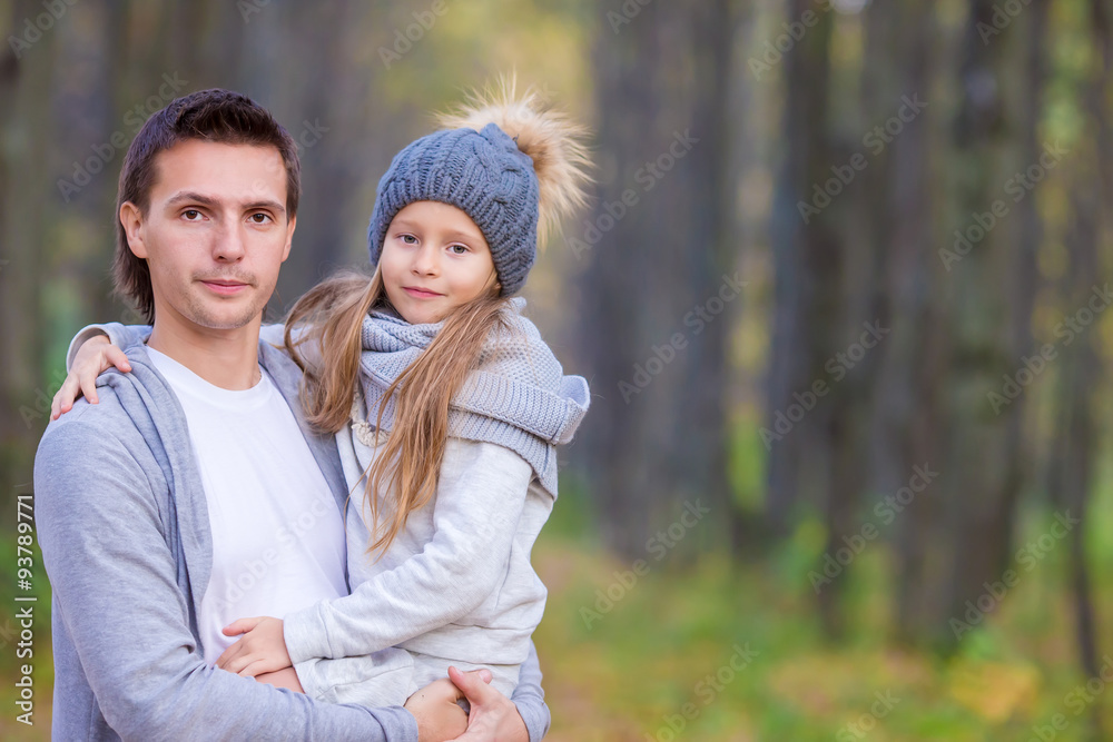 Fototapeta premium Little adorable girl with happy dad in autumn park outdoors