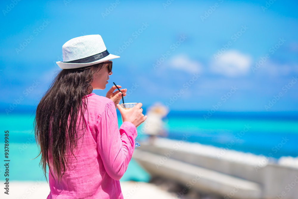 Young woman with tasty cocktail on summer vacation