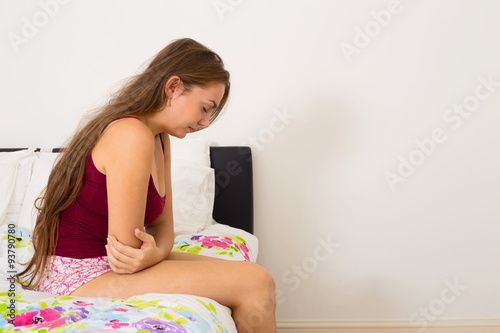 young woman suffering from period pains photo