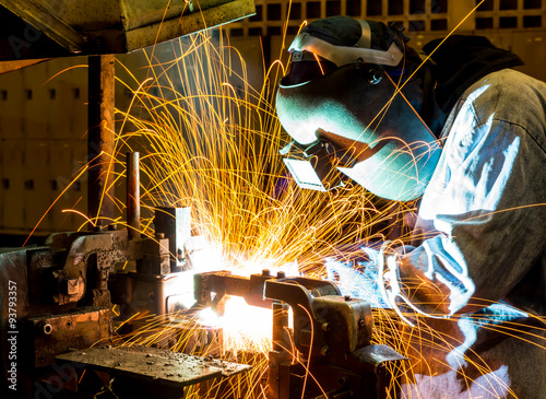 sparks while welder uses torch to welding