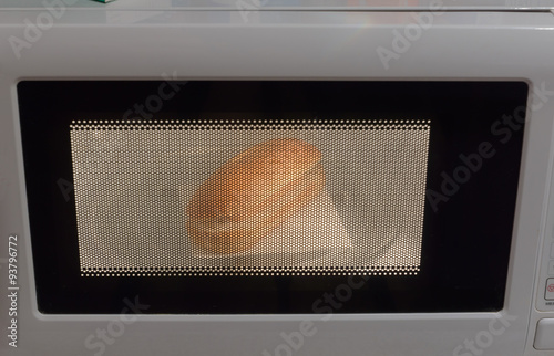 sausage and bread are warmed in the microwave oven