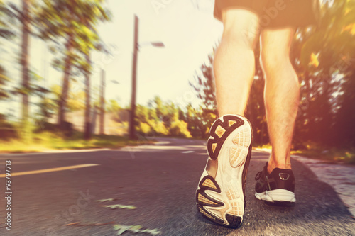 Athlete man jogging outside at sunset