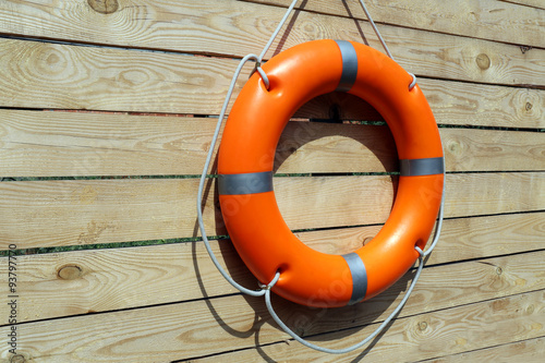 A life buoy on wooden background