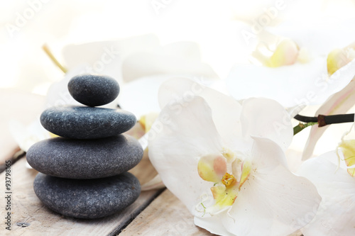 Set of pebbles and orchid on wooden background
