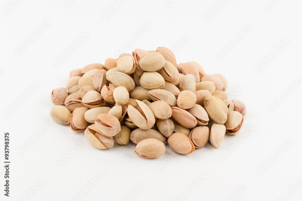 hill of pistachios in a shell lies on a white background hill of pistachios in a shell lies on a white background